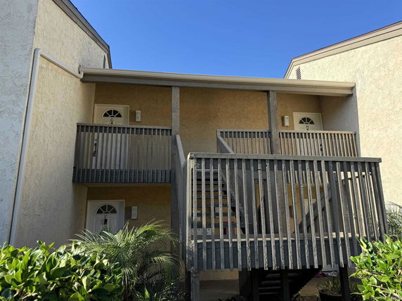 Front view of a building with exterior staircases and balconies.