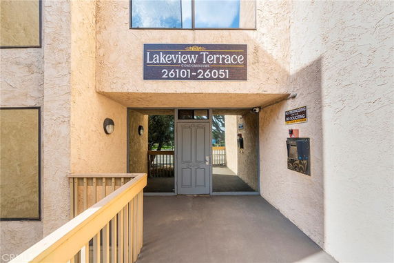 Entrance view of a condominium complex with a sign reading 'Lakeview Terrace 26101-26051'.