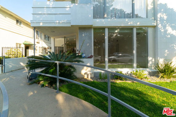 Front view of a modern multi-story building with large windows.