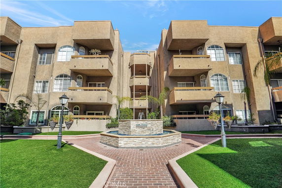 Front view of a multi-story apartment building with balconies.