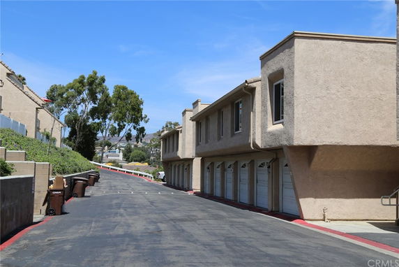 Front view of a multi-story residential building with garages.