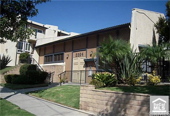 Front view of a multi-story residential building with modern architectural design.