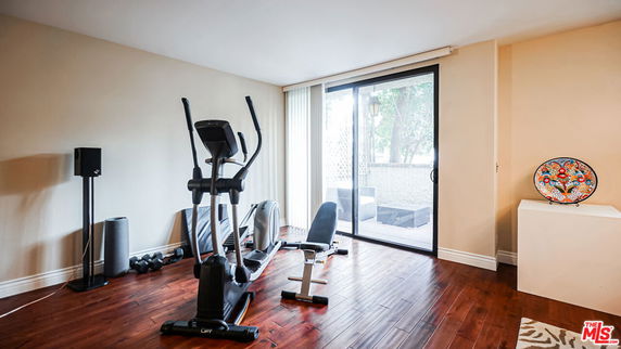 Indoor room with exercise equipment and large window.