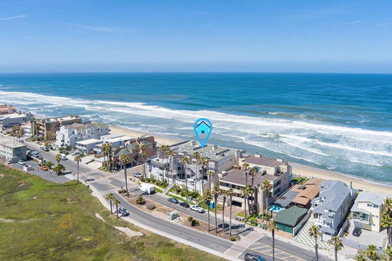 Panoramic view of beachfront properties along the coast.