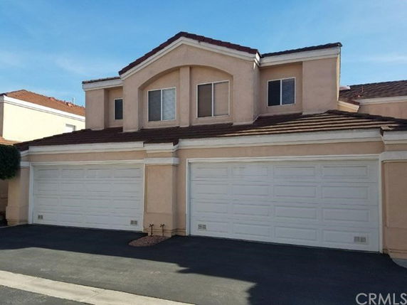 Front view of a two-story house with three garages.