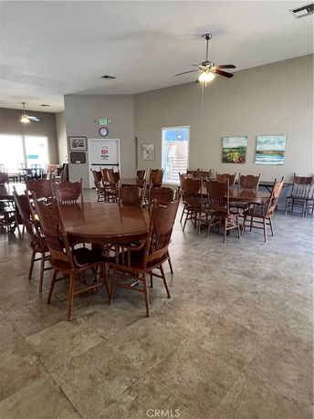 Interior view of a recreational space with multiple tables and chairs.
