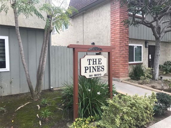 Front view of a building with a sign reading 'The Pines, 360 Obispo.'