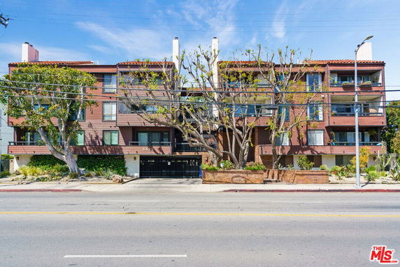 Front view of a multi-story residential building with balconies.