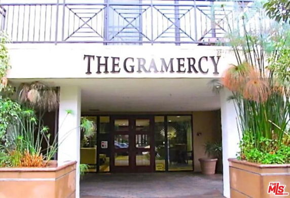 Front view of a building entrance with signage reading 'THE GRAMERCY.'