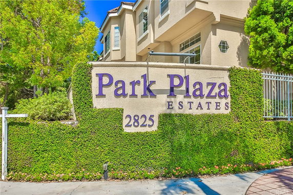 Front view of a multi-story building with a sign that reads 'Park Plaza Estates'.