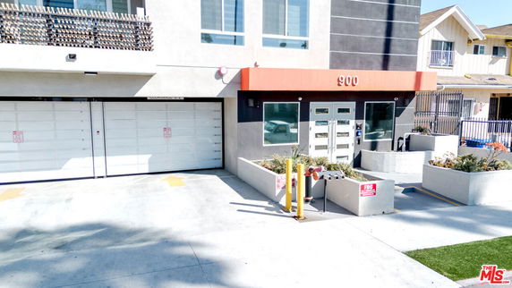 Front view of a modern building with a double garage and entrance.
