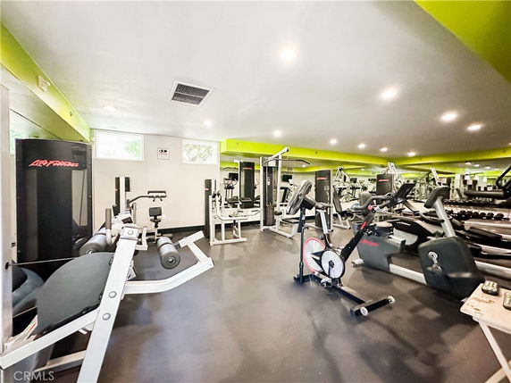 Indoor gym area with exercise equipment and mirrors.