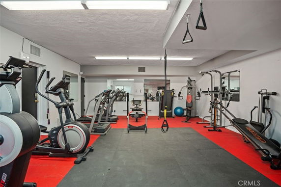 Interior view of a gym with various exercise equipment.