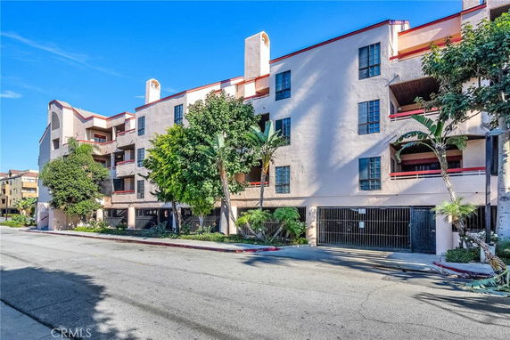 Front view of a multi-story residential building with balconies.