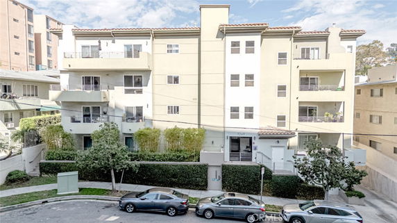 Front view of a multi-story residential building with balconies.