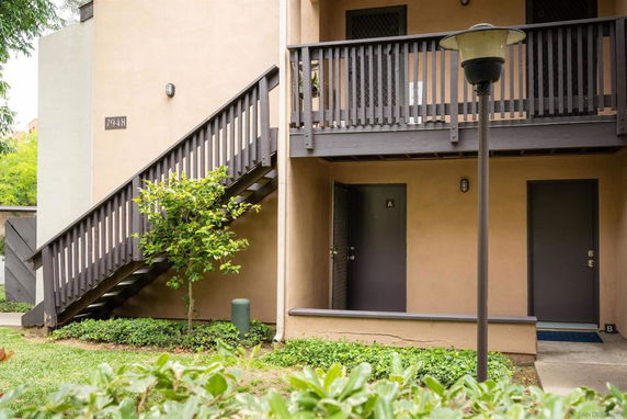 Front view of a building with an outdoor staircase and two doors labeled A and B.