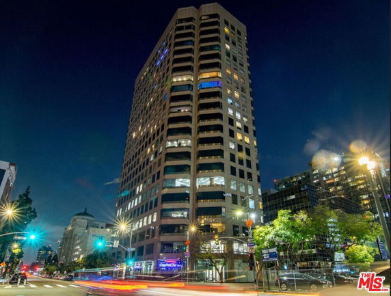 Front view of a high-rise building at night.