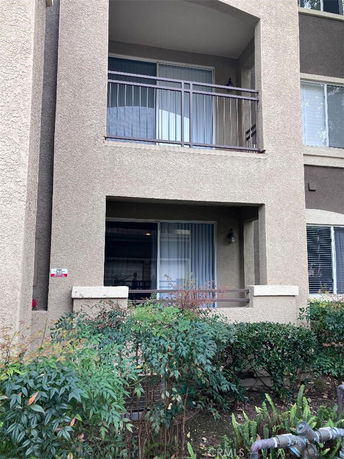 Front view of a multi-story building with balconies.
