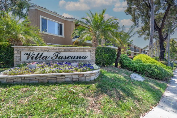 Front view of a residential building named Villa Tuscana with a landscaped entrance.