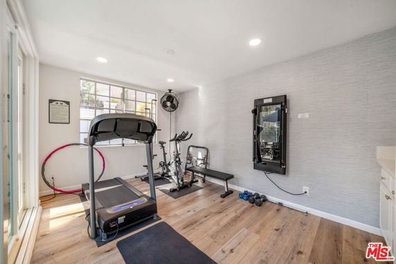 Indoor exercise area with gym equipment including treadmill and stationary bike.
