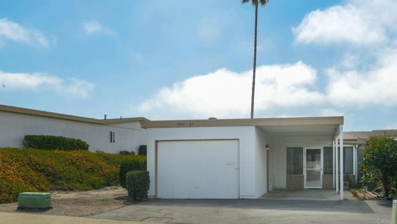 Front view of a single-story house with a covered entryway and garage.