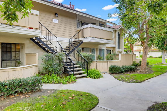 Front view of a two-story building with exterior stairs and balconies.