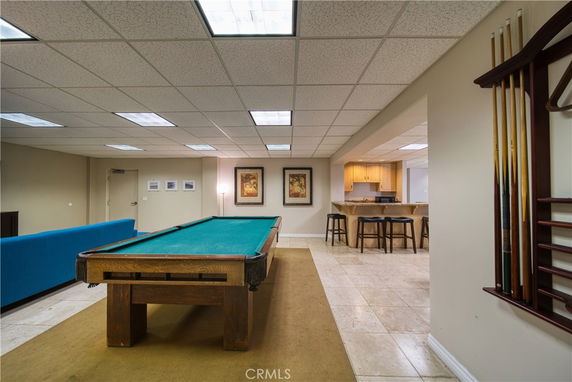 Interior with a billiards table and bar seating area.