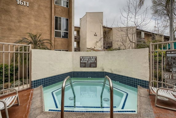 Outdoor spa area with surrounding buildings.
