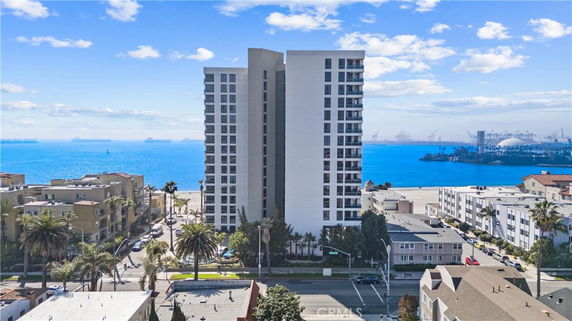 Front view of a tall residential building near the coastline.