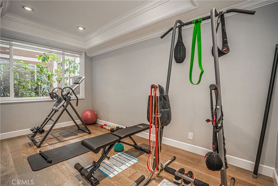 Home gym area with exercise equipment and large window.