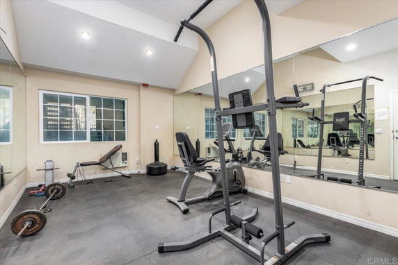 Indoor gym area with exercise equipment including weights and a bench press.
