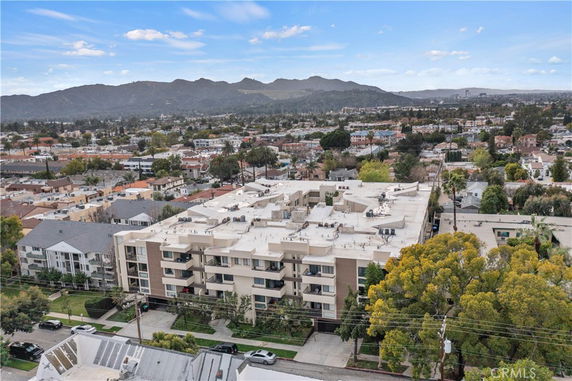 Aerial view of a multi-story building surrounded by residential and commercial areas.