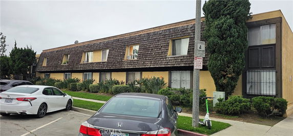 Front view of a two-story apartment building with a shingle roof.