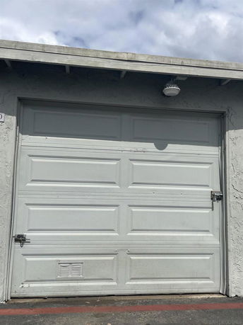 Front view of a white garage door in a residential building.