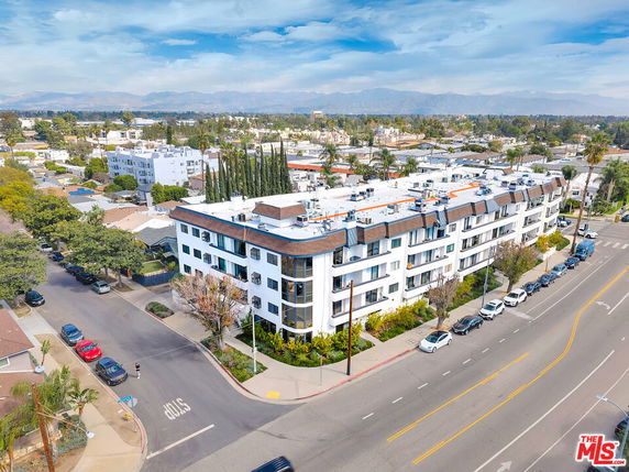 Aerial view of a multi-story residential building with a corner location.