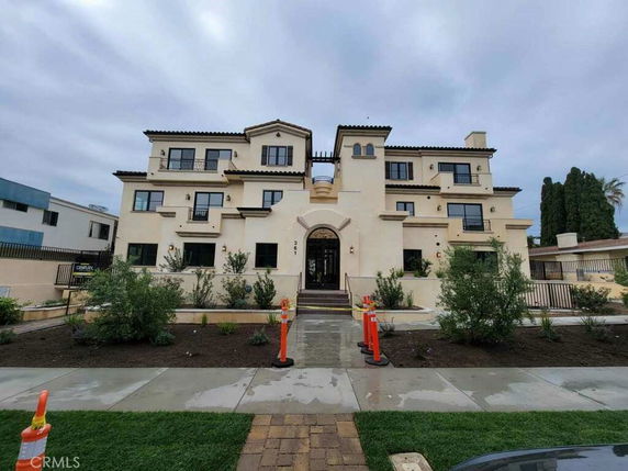 Front view of a multi-story building with a symmetrical design.