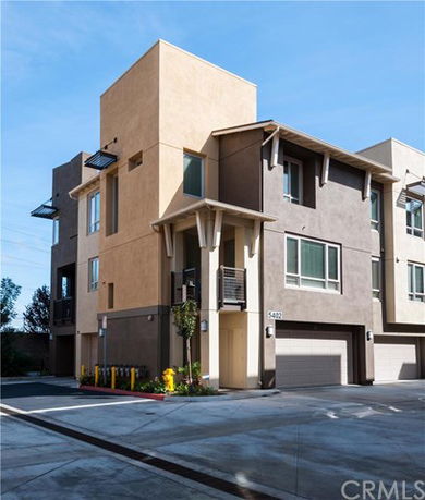 Front view of a modern multi-story building with a garage.