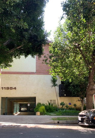 Front view of a building with an entrance gate and visible street number.