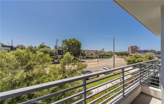 View of surrounding streets and buildings seen from a balcony.