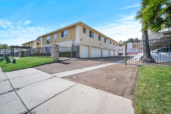 Front view of a two-story apartment building with multiple garages.