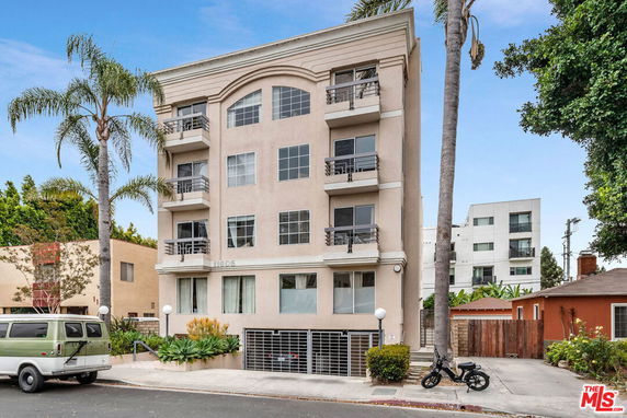 Front view of a multi-story residential building with balconies.