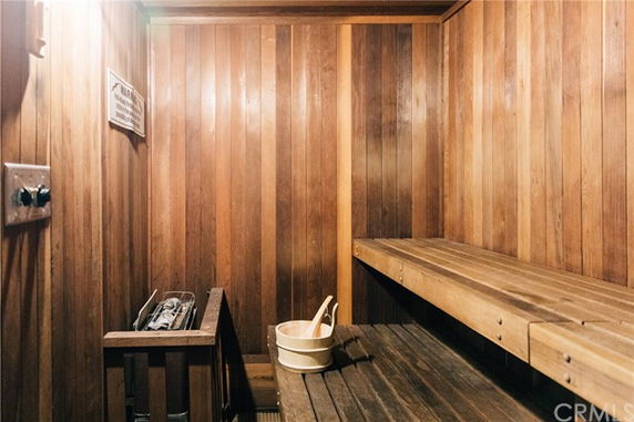 Interior of a wooden sauna room with benches and a heater.