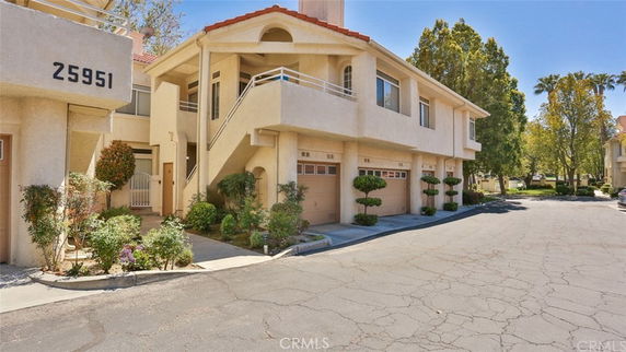 Front view of a two-story townhouse with attached garages.