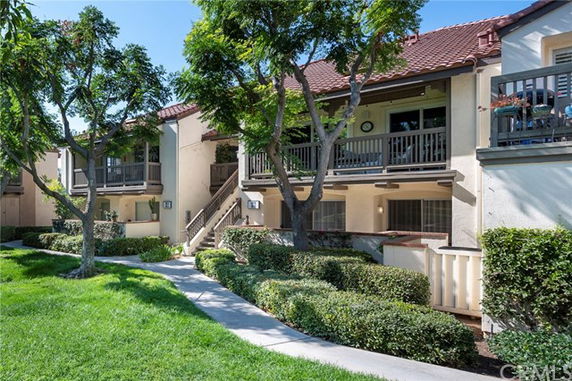Front view of a two-story building with balconies and a tiled roof.