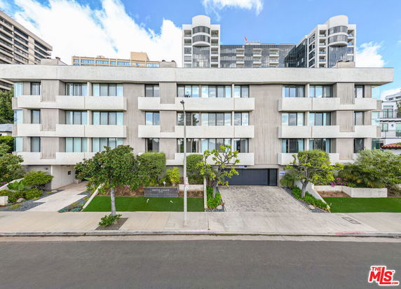 Front view of a multi-story residential building with modern architectural design.