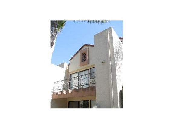 Front view of a two-story house with a balcony.