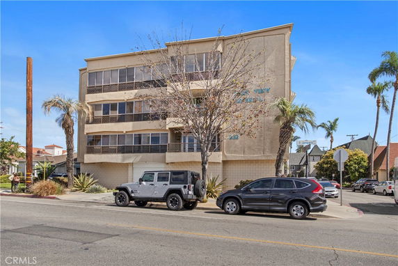 Front view of a multi-story residential building with balconies.