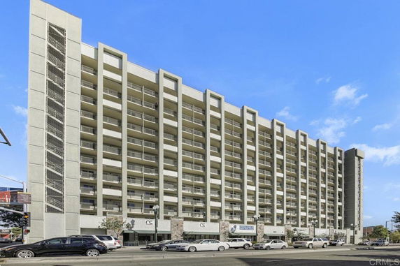Front view of a multi-story residential building with balconies.