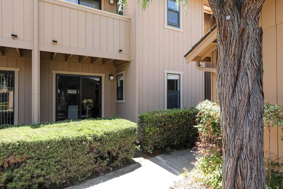Front view of a building with sliding glass doors and wooden paneling.