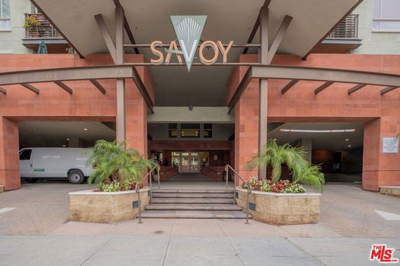 Front view of a building with the sign 'Savoy' and an entrance area.